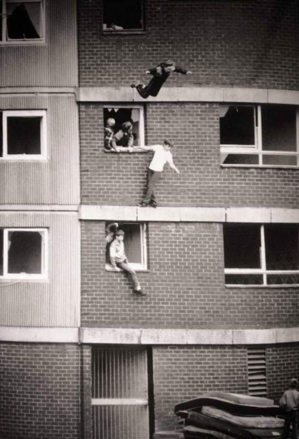 children bouncing on worn out mattresses in england 1980s